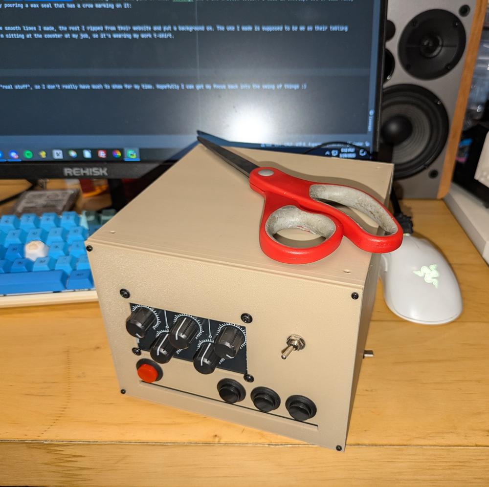 A 3d printed box shape, about the size of a pair of scissors corner to corner. It has volume knobs, buttons, and a switch in the front. It has a slot for accepting a CD.